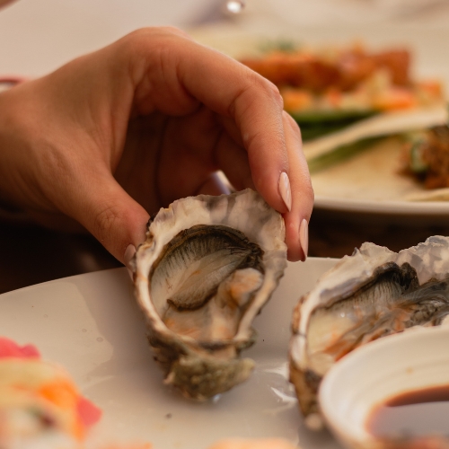 woman holding an oyster